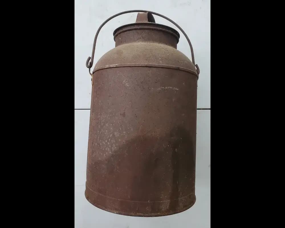 Vintage rusty metal milk can